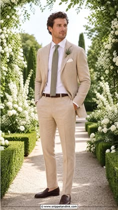 Beige linen suit with a soft tie in a garden setting